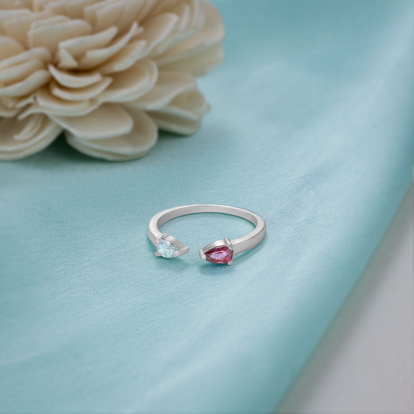 silver ring with a pink stone and a diamond