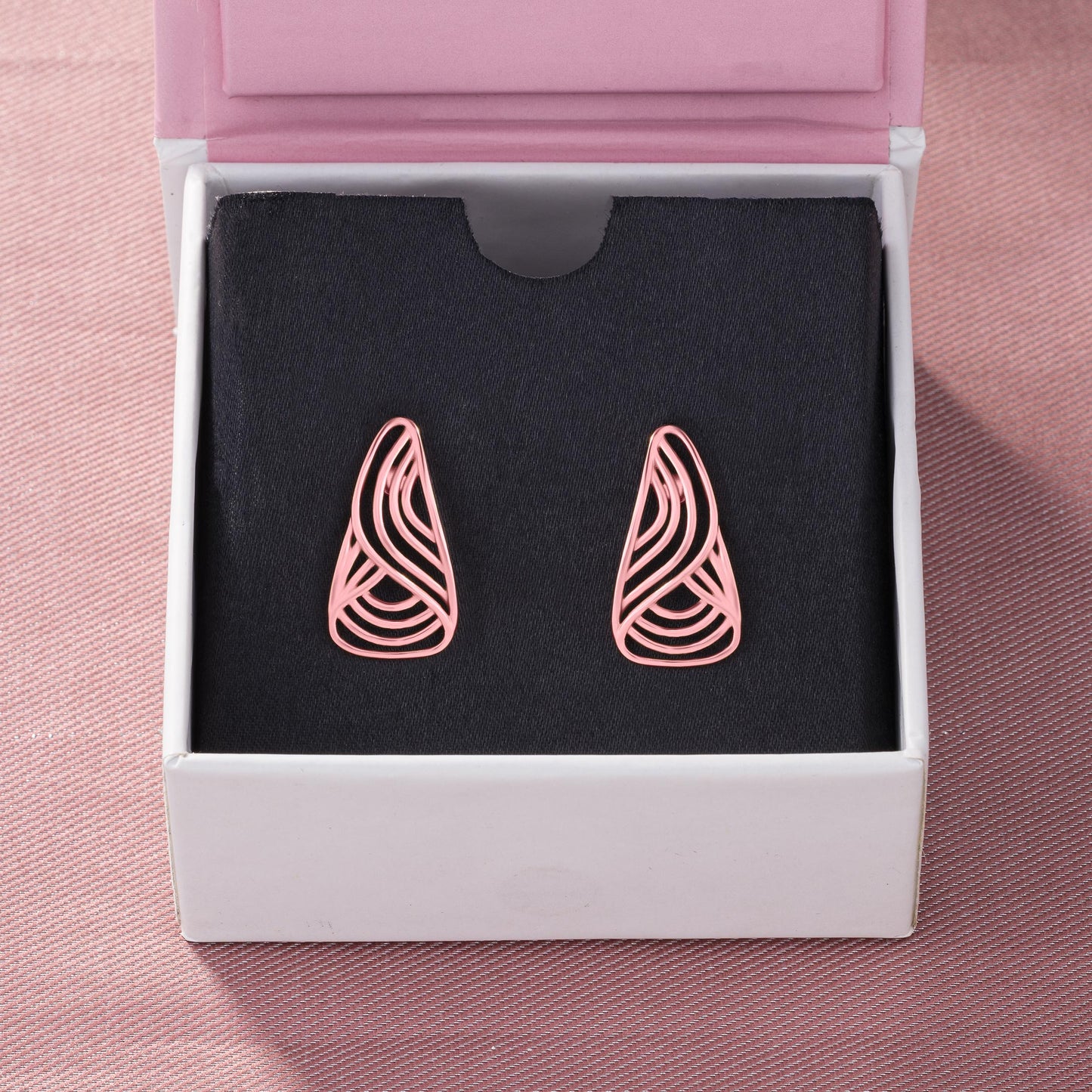 pair of rose gold earrings