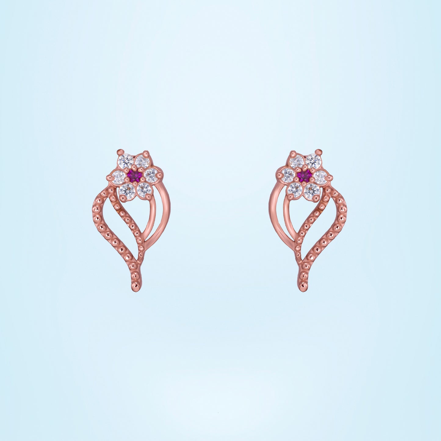 pair of rose gold earrings with diamonds and stones