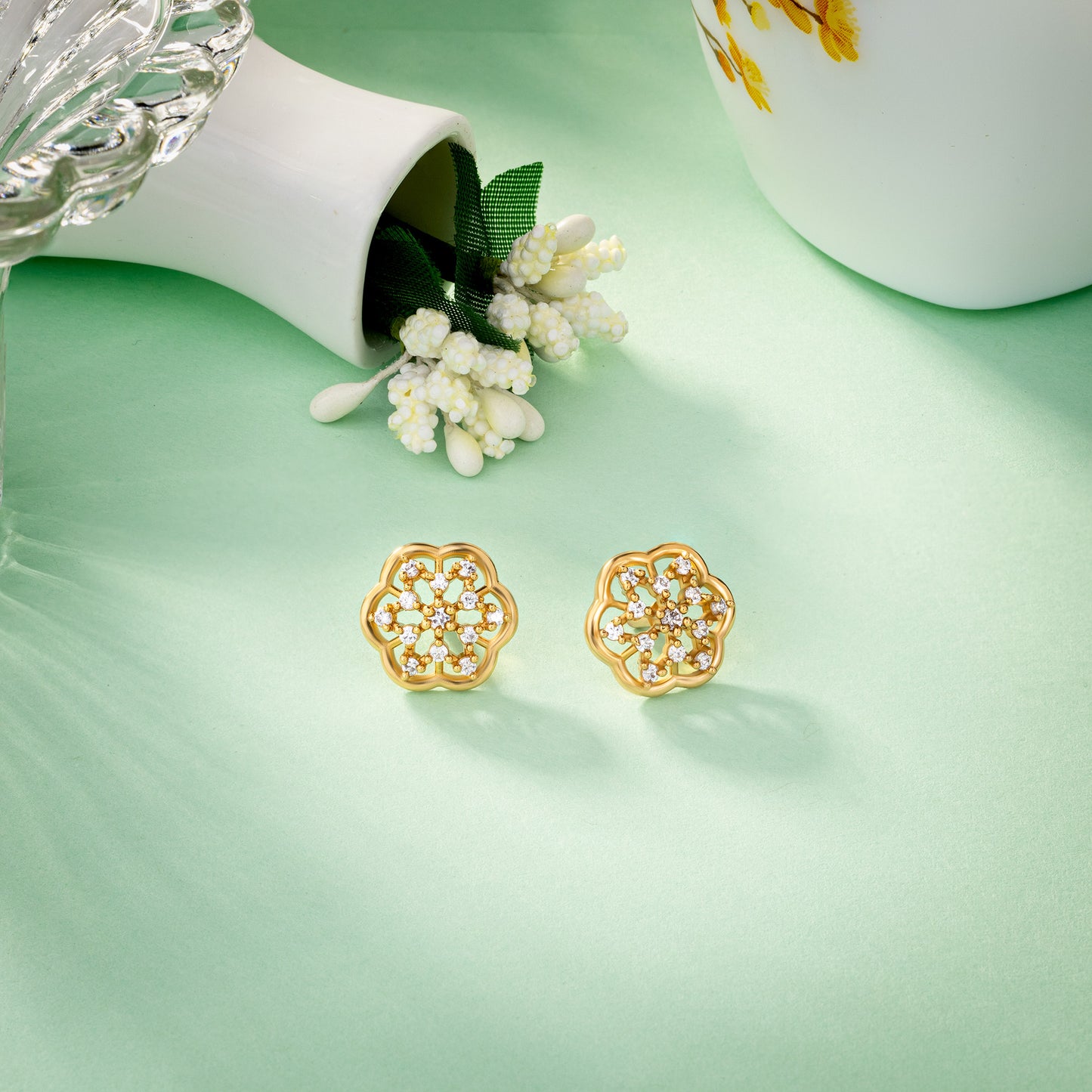 pair of golden earrings with white diamonds