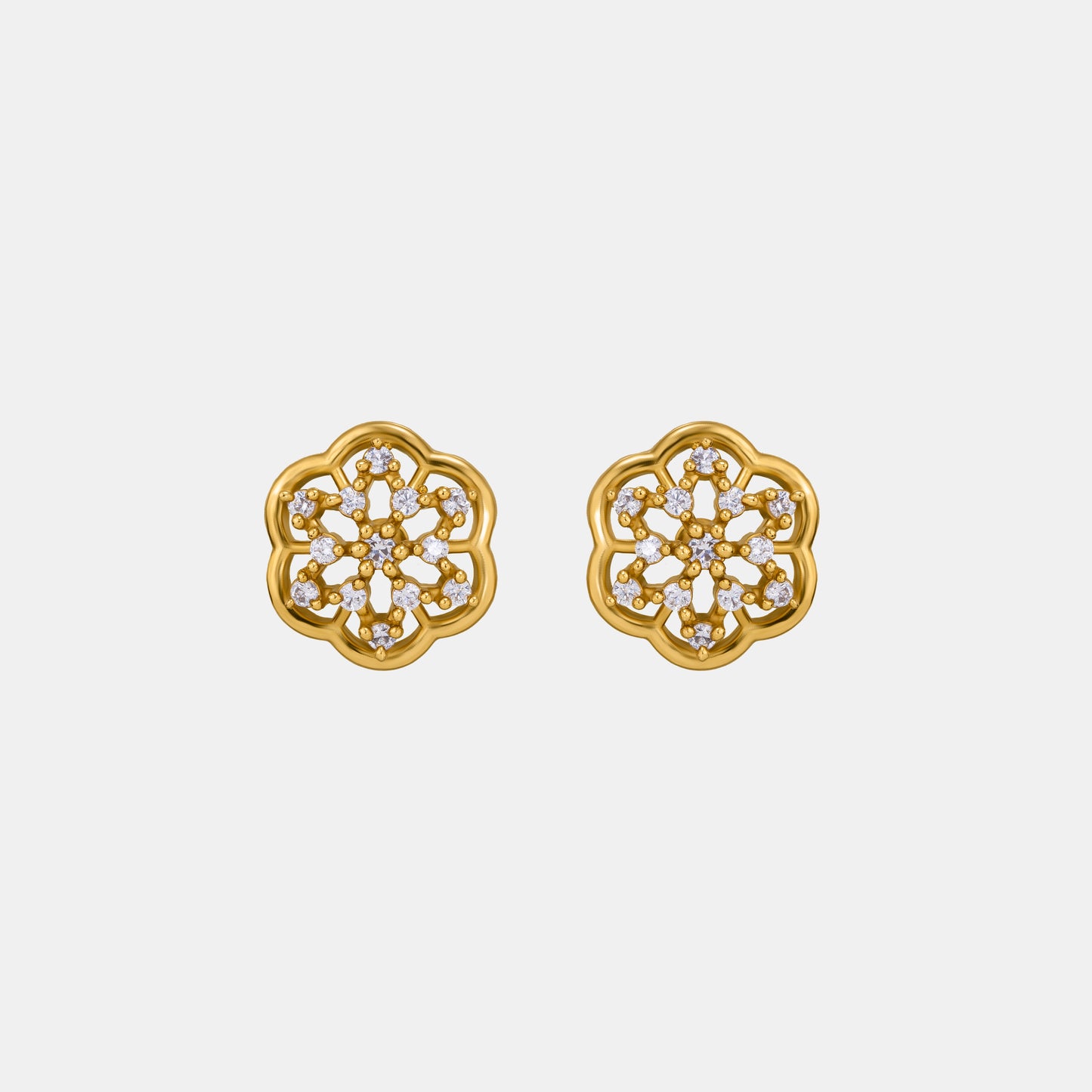 pair of golden earrings with white diamonds