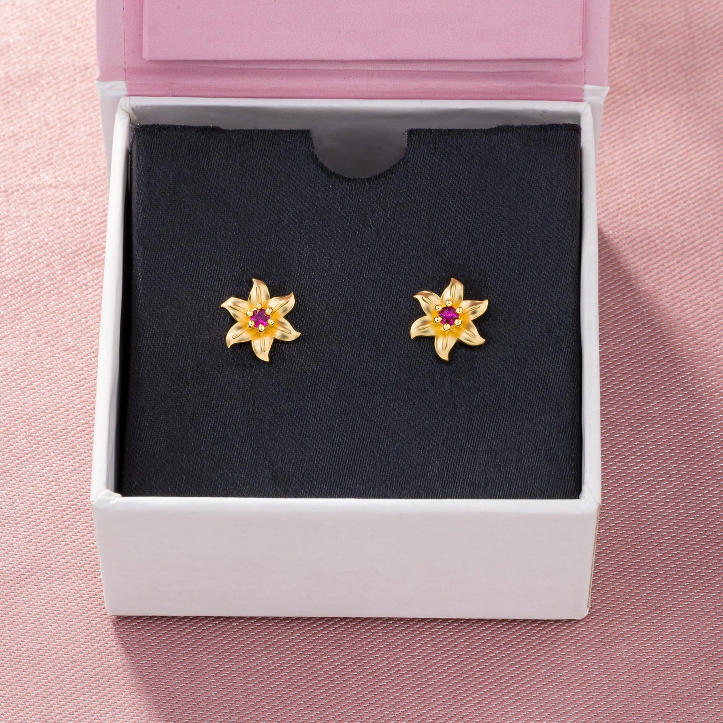 pair of golden earrings with white stones