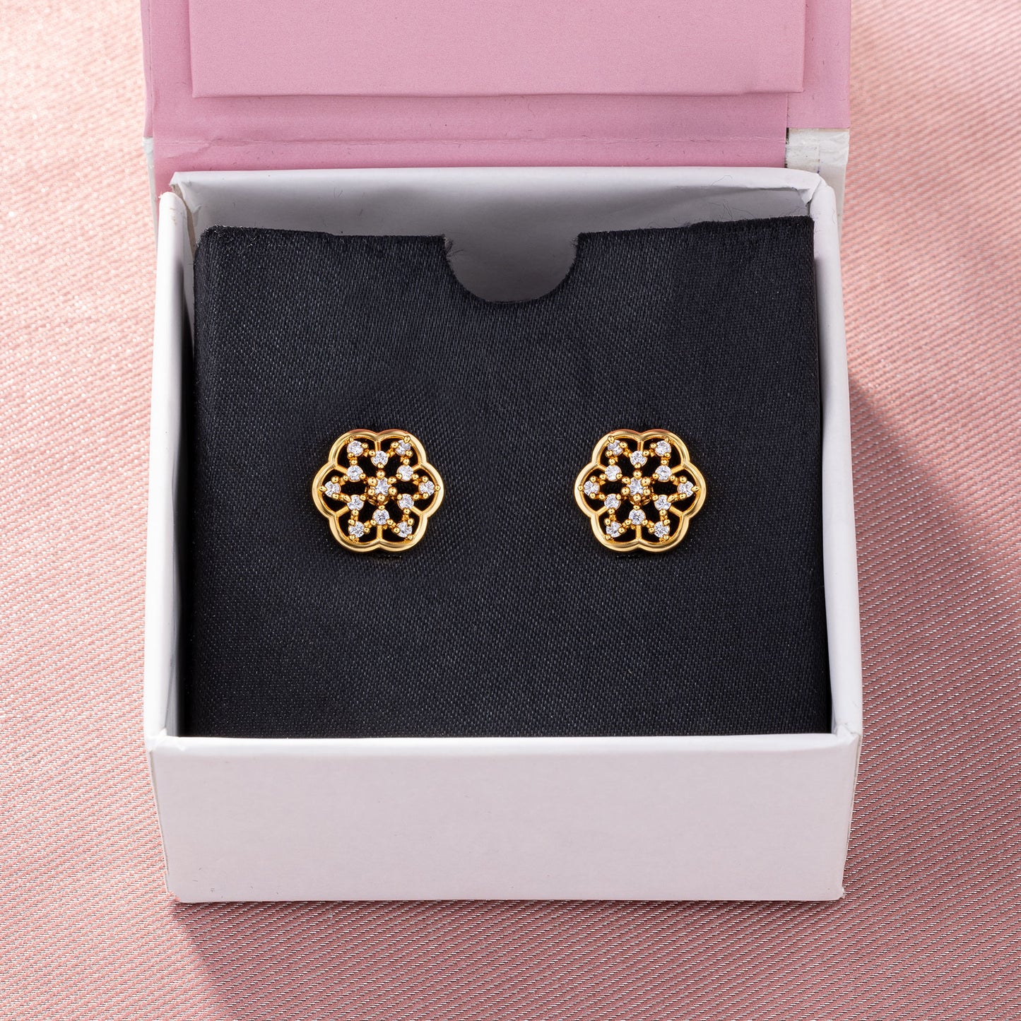 pair of golden earrings with white diamonds