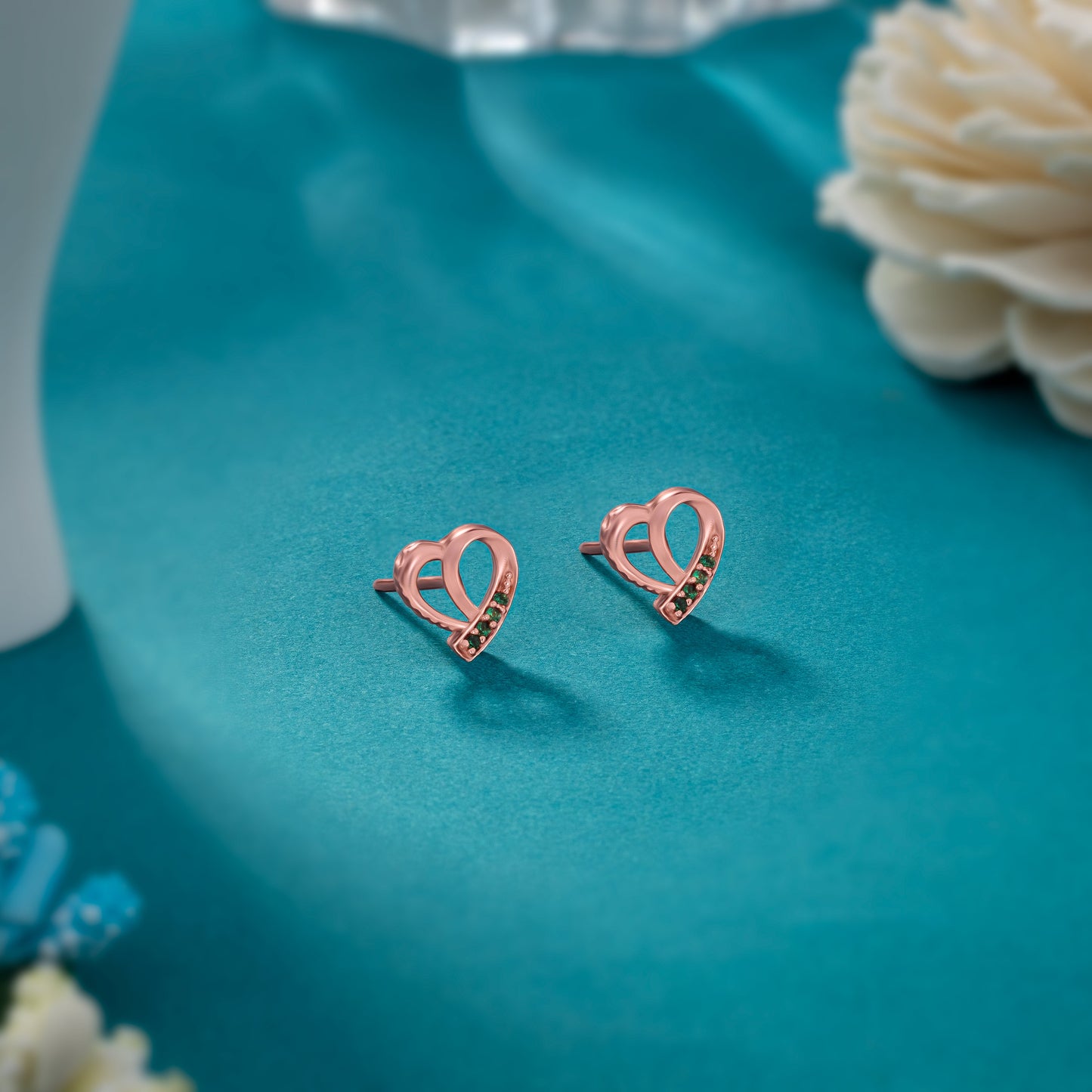 pair of rose gold earrings with sapphire stones