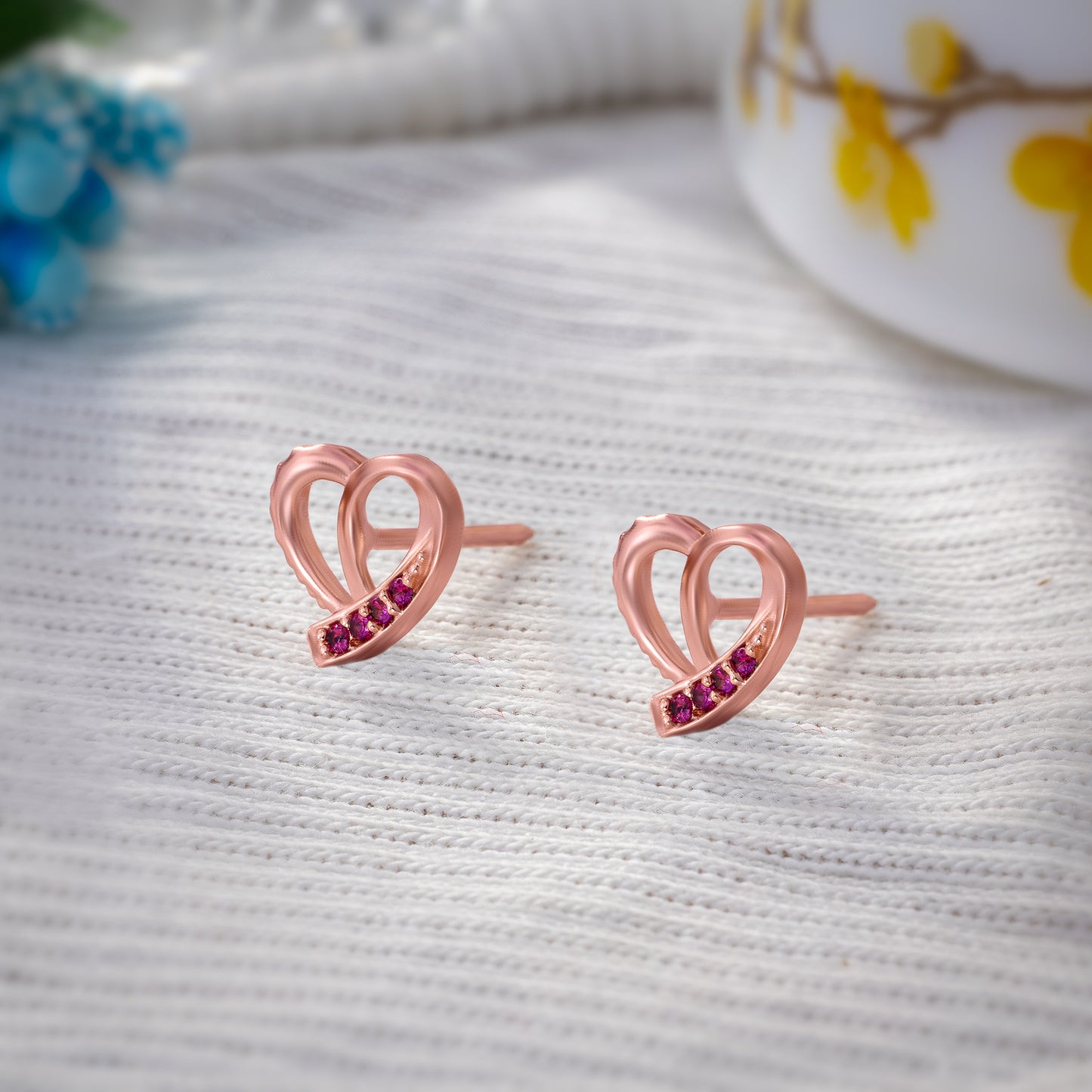 pair of rose gold earrings with sapphire stones