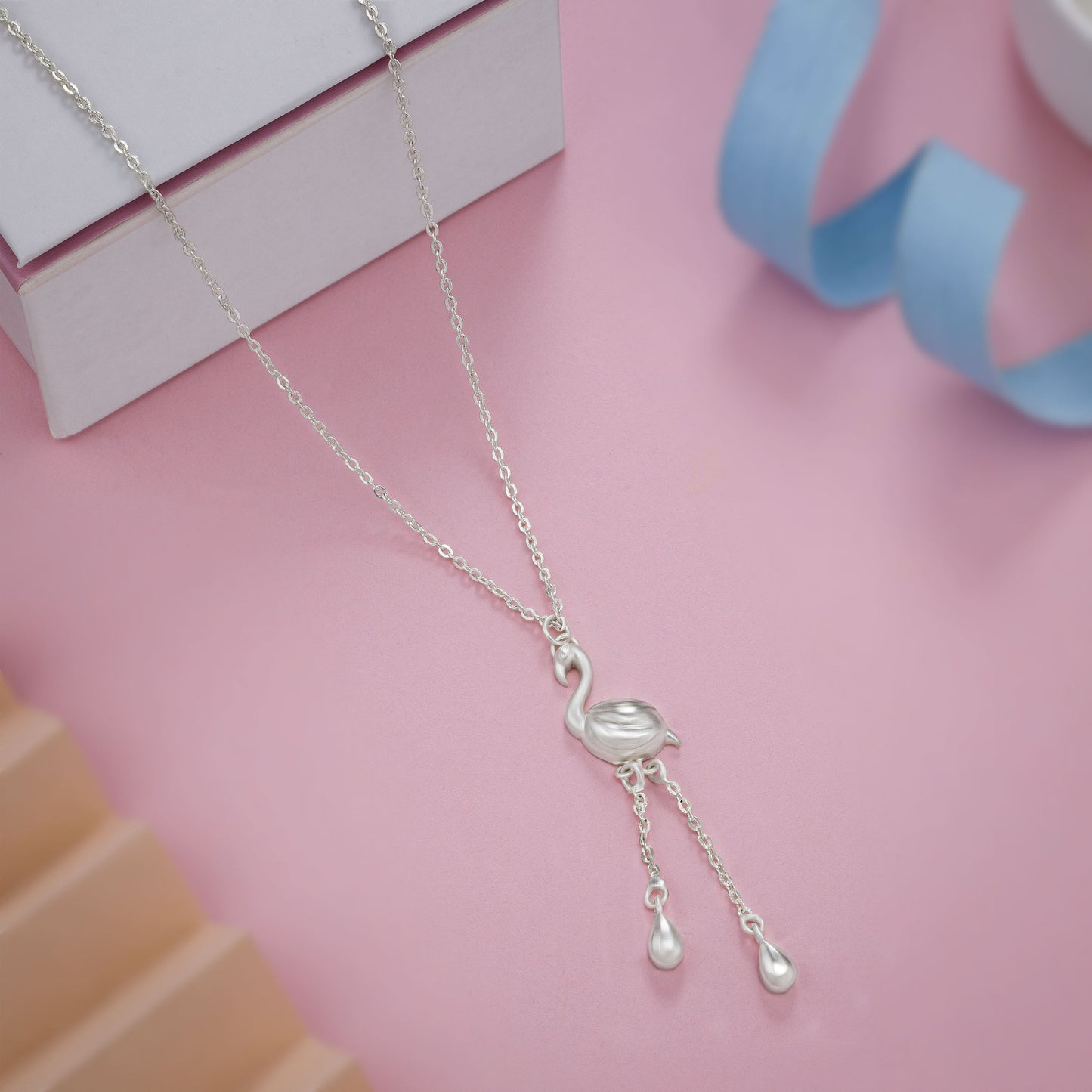 silver necklace with a small bird