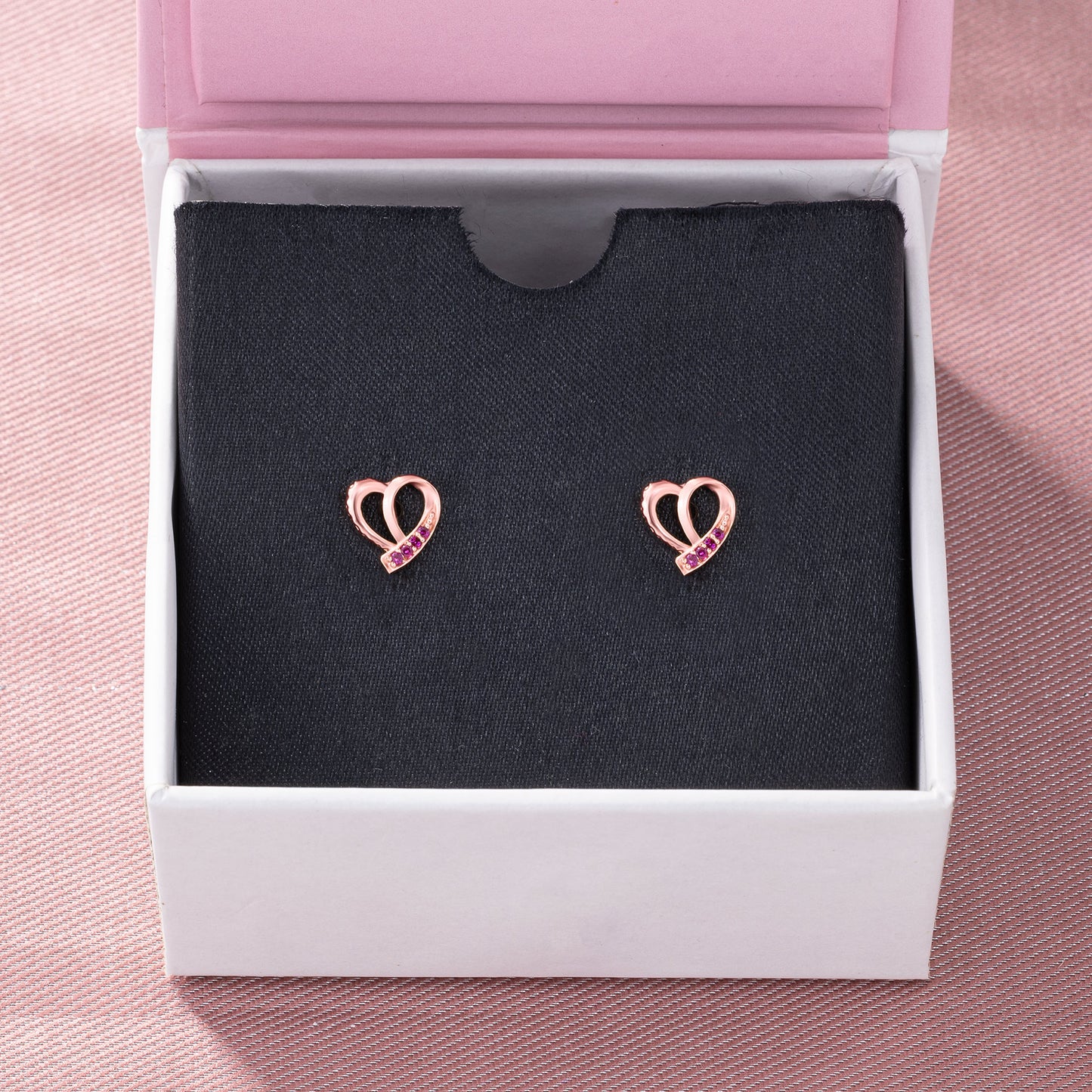 pair of rose gold earrings with sapphire stones