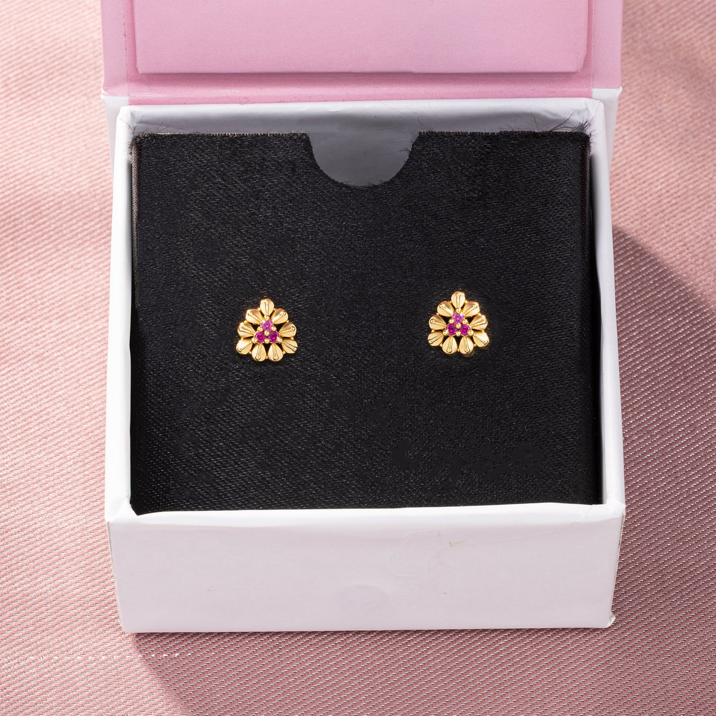 pair of golden and flower earrings