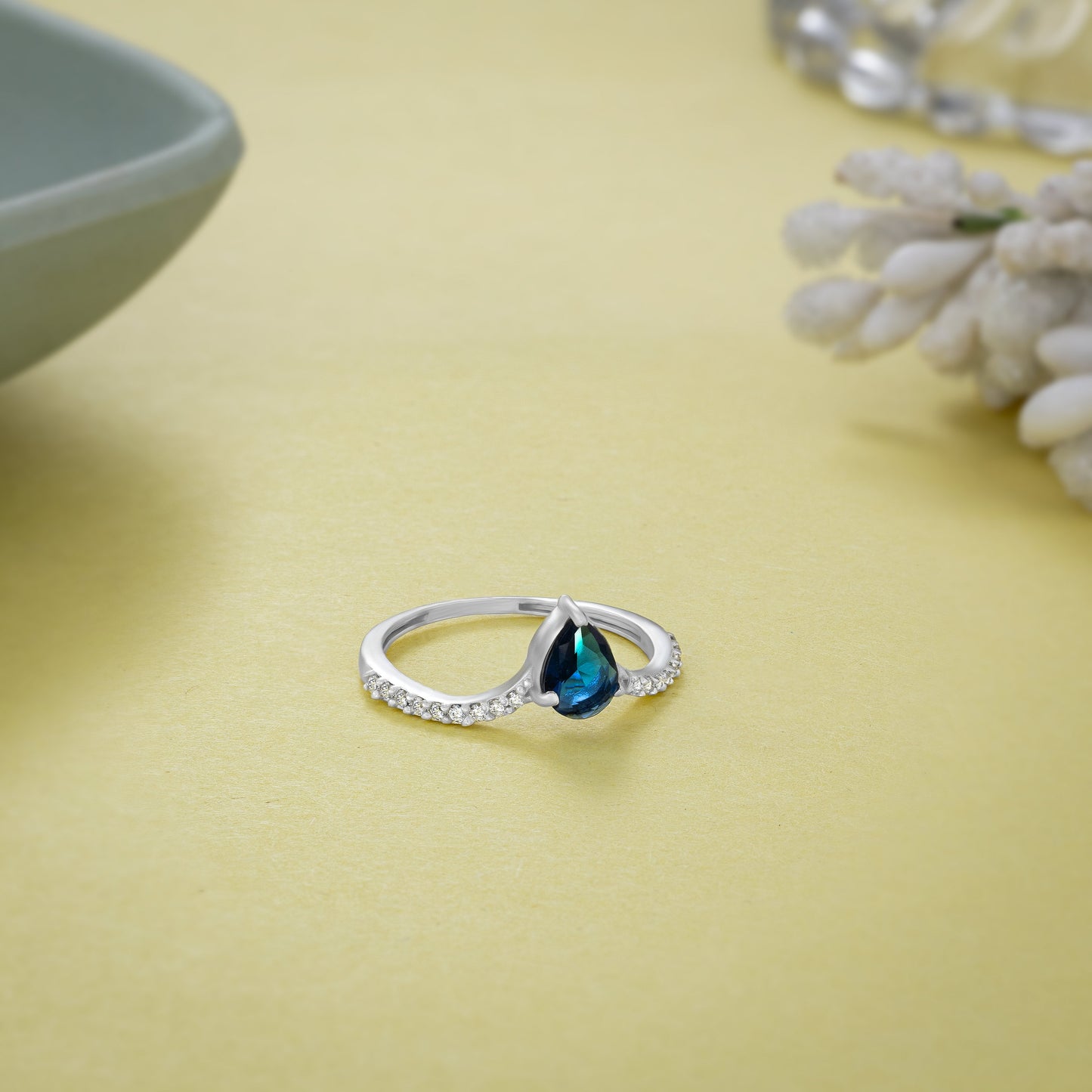 silver ring with a sapphire and diamonds