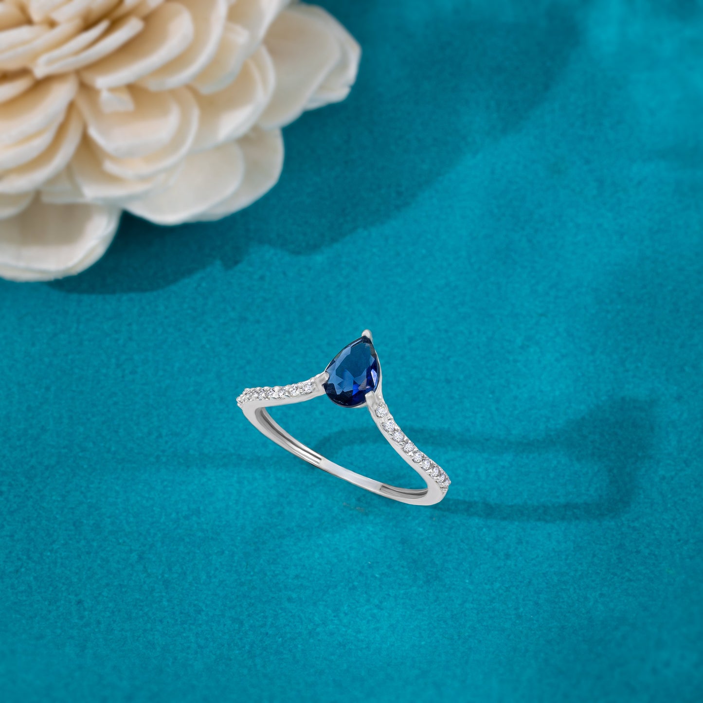 silver ring with a sapphire and diamonds