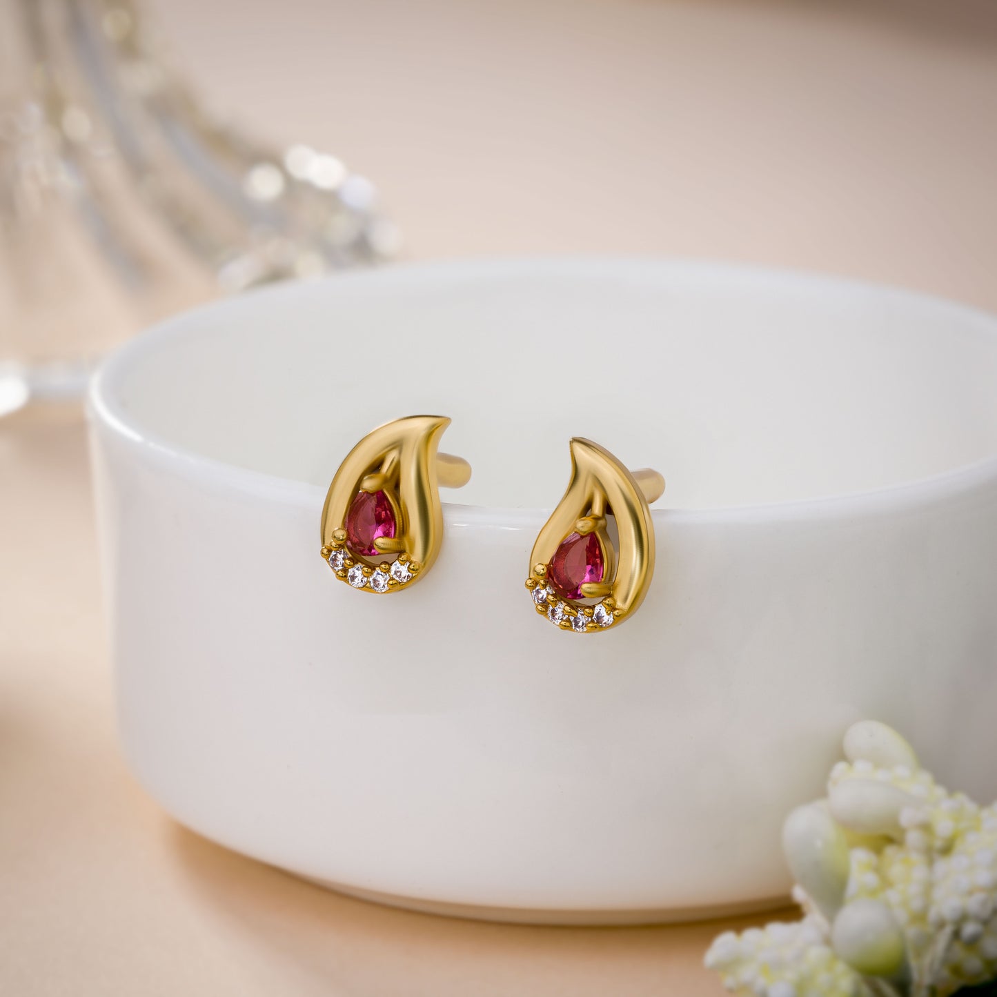 pair of golden earrings with stones