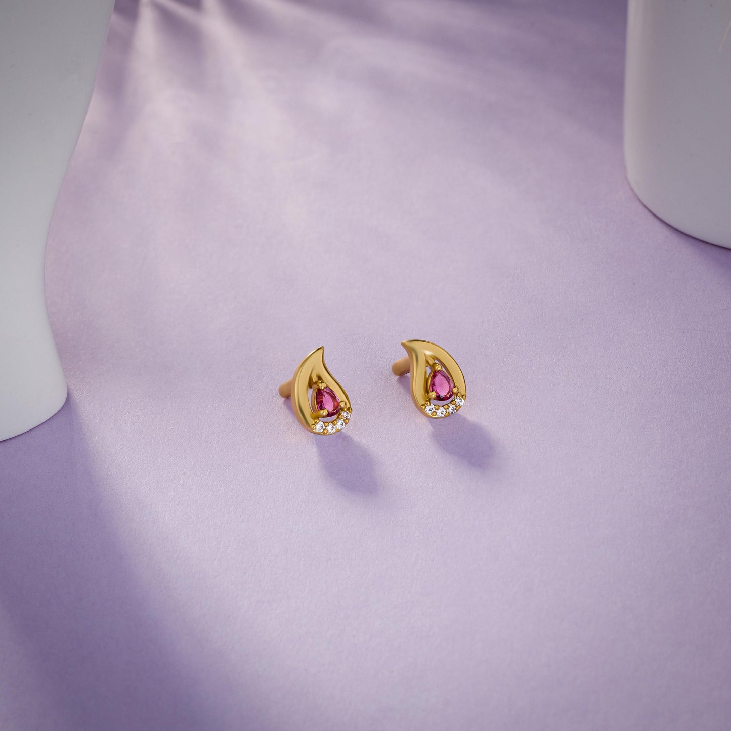 pair of golden earrings with stones