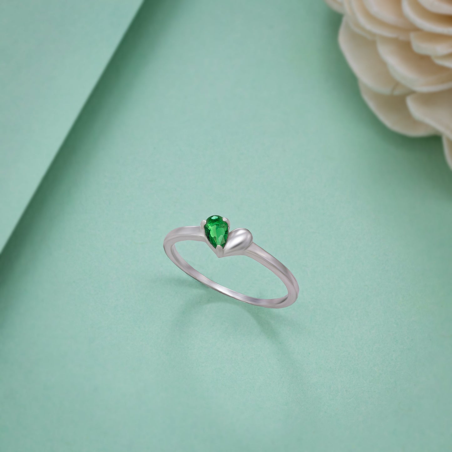 silver ring with a green stone