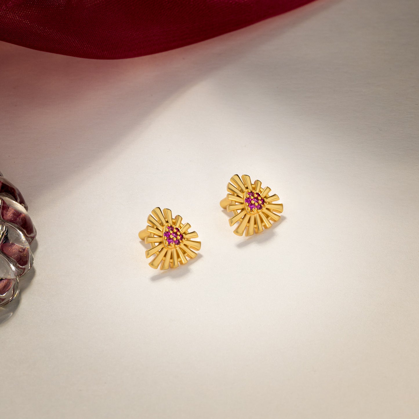 pair of golden earrings with stones