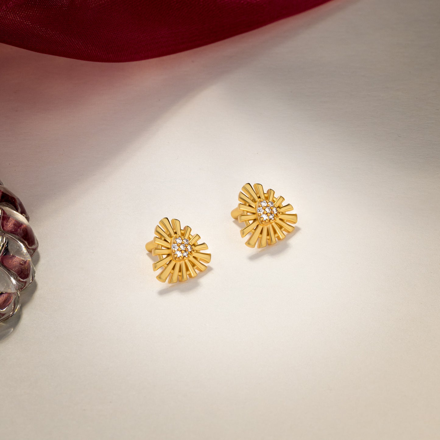 pair of golden earrings with stones