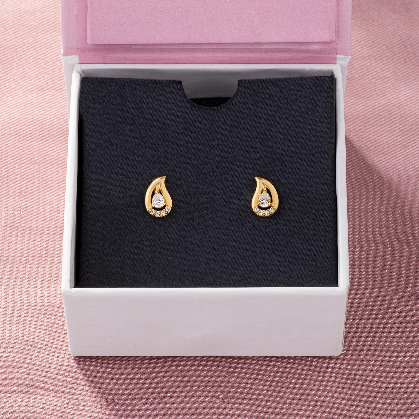 pair of golden earrings with white stones