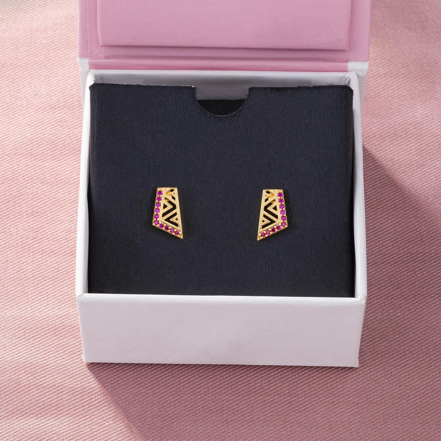 pair of golden earrings with stones