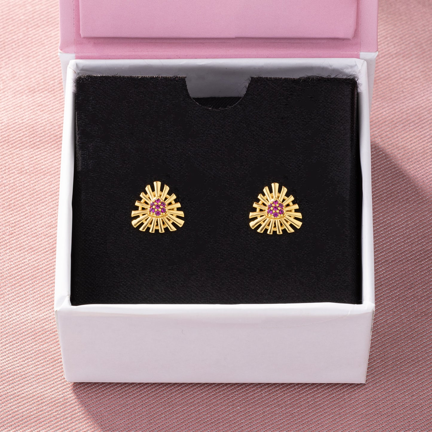 pair of golden earrings with stones