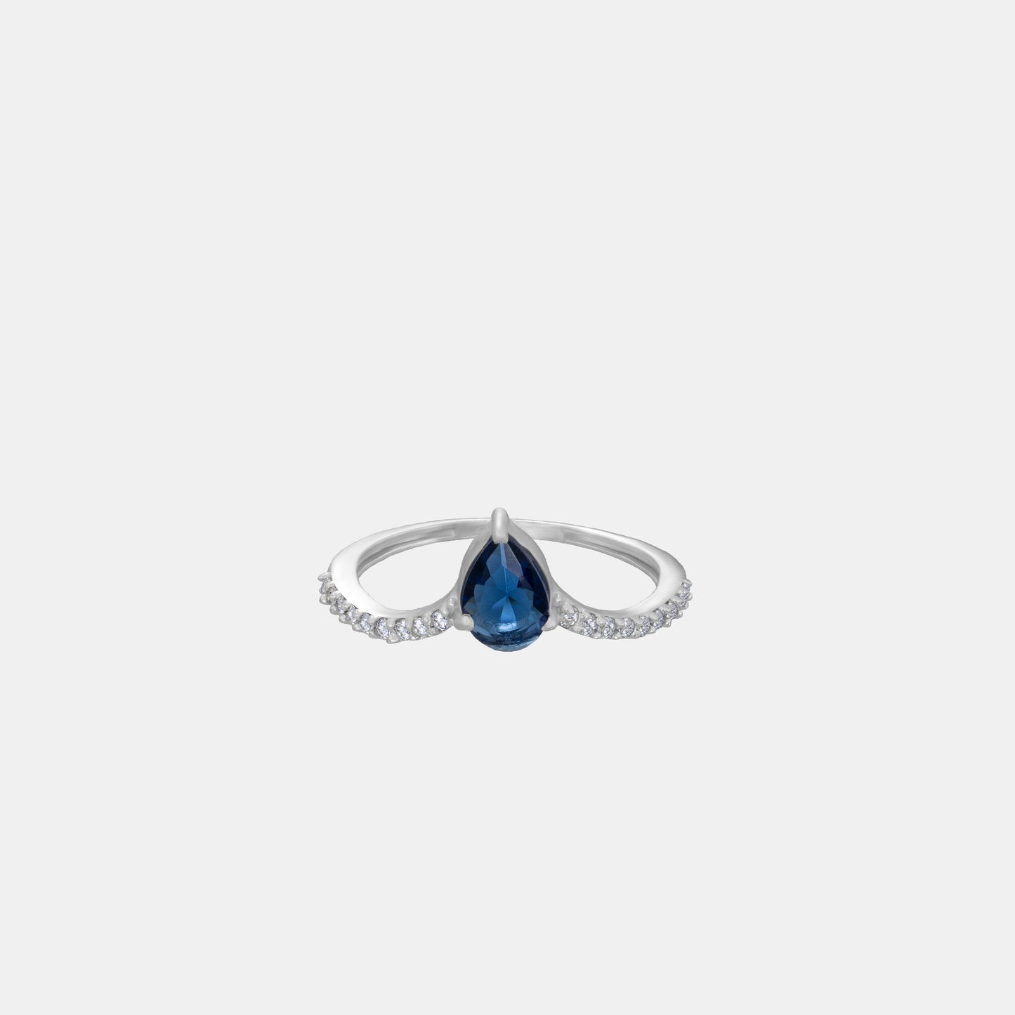 silver ring with a blue sapphire and diamonds