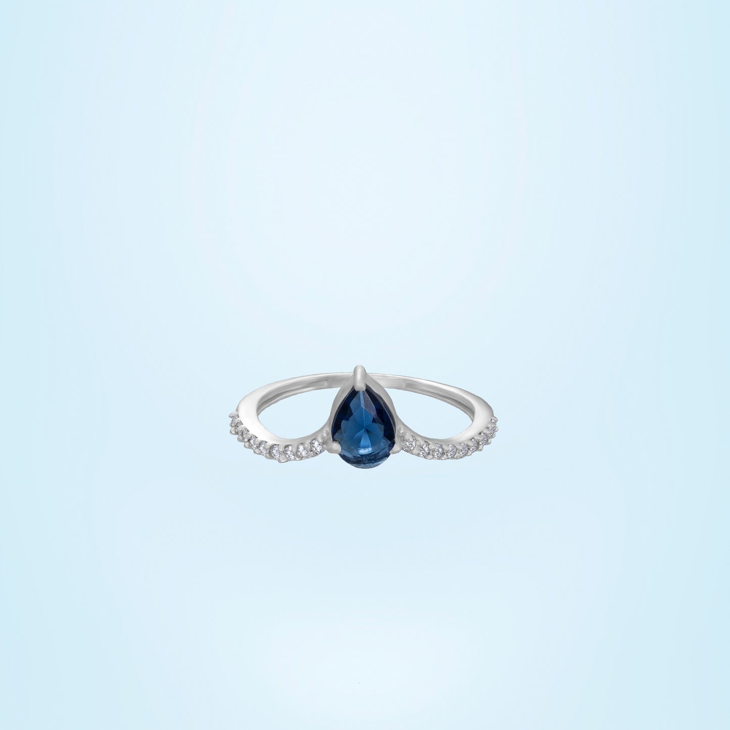 silver ring with a sapphire and diamonds