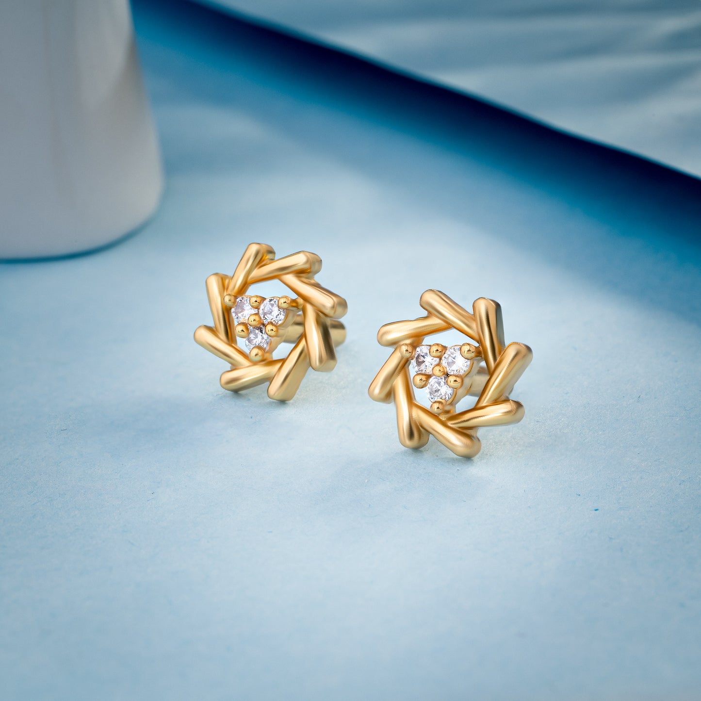 pair of golden earrings with a diamond