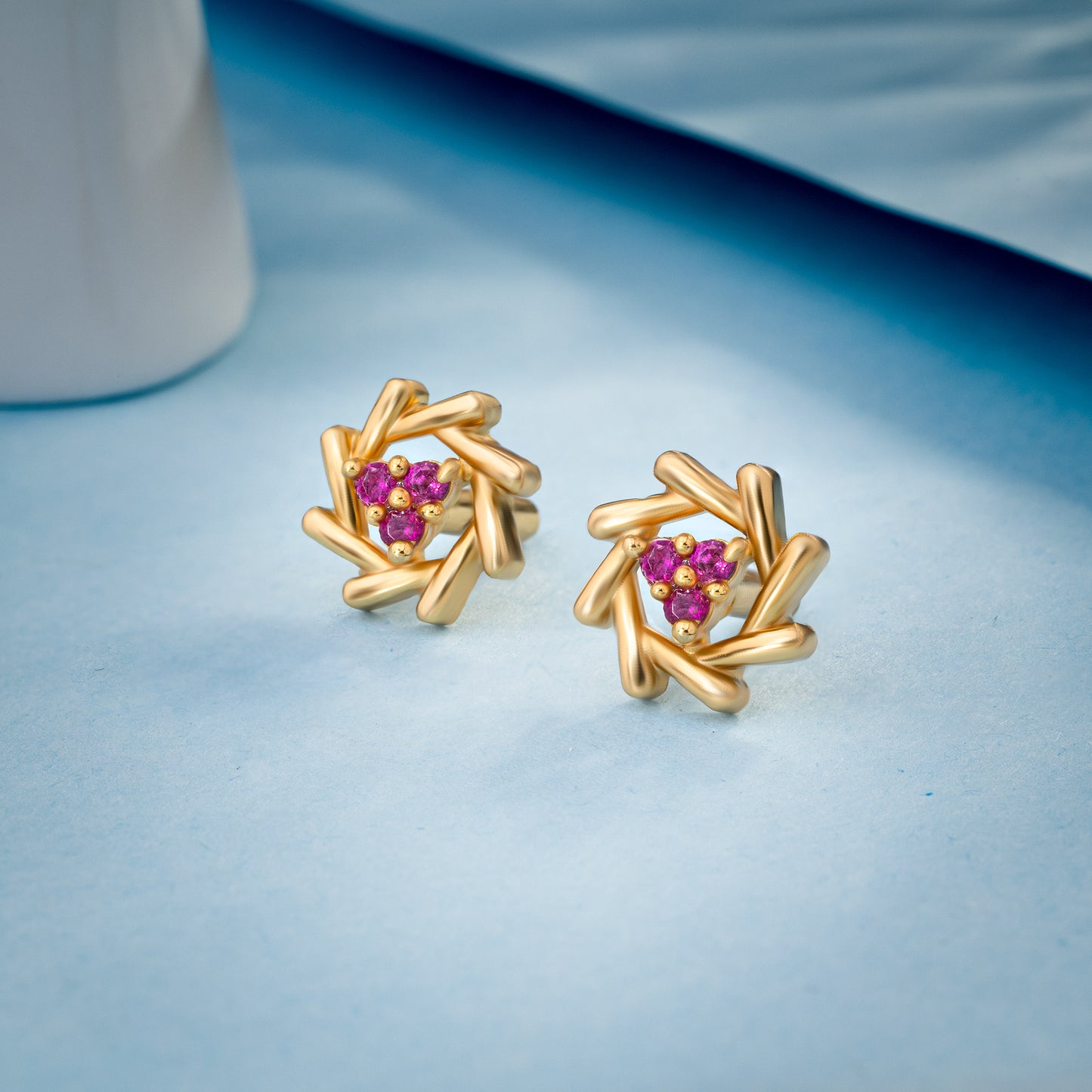 pair of golden earrings with a diamond