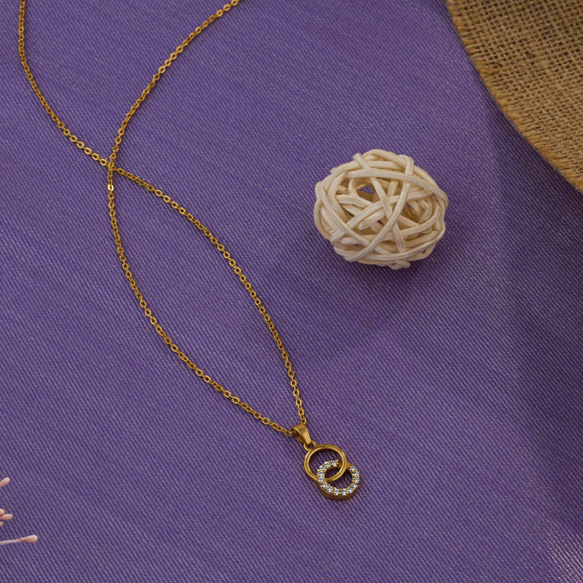 golden necklace with a diamond pendant