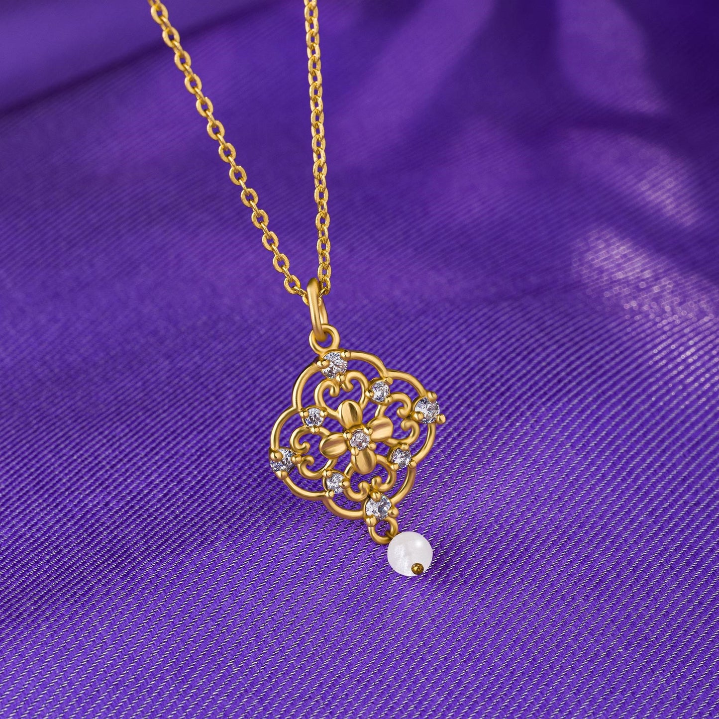 golden necklace with a flower design on it