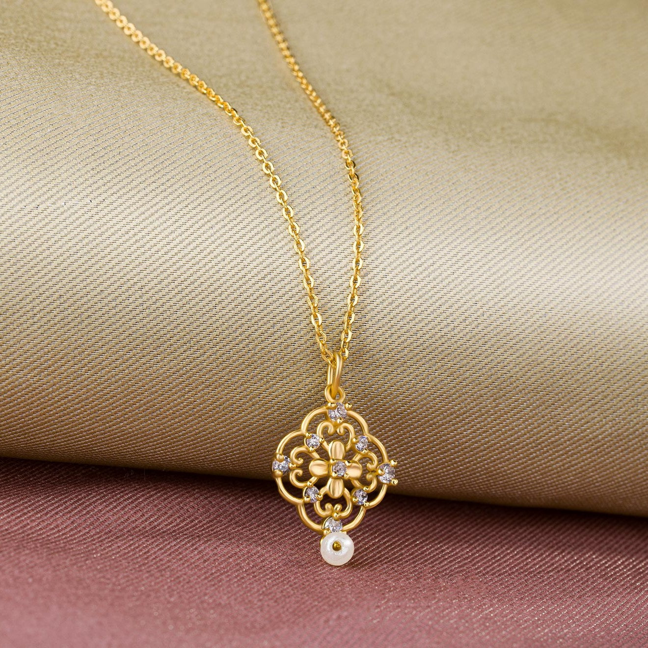 golden necklace with a flower design on it