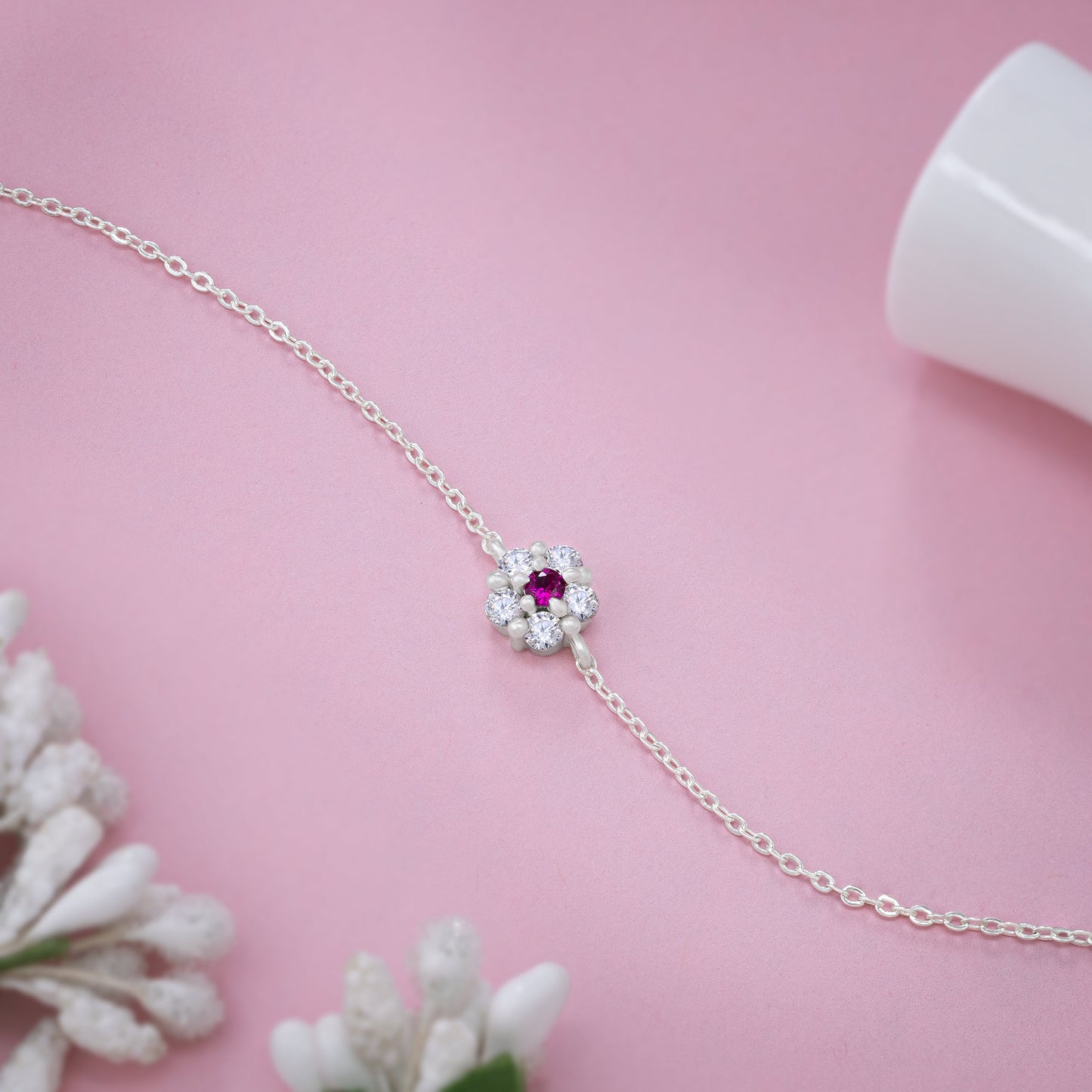 silver floral bracelet with red diamond stone petals