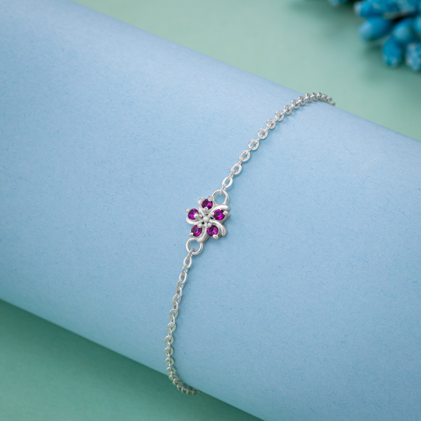 silver bracelet with a red stone