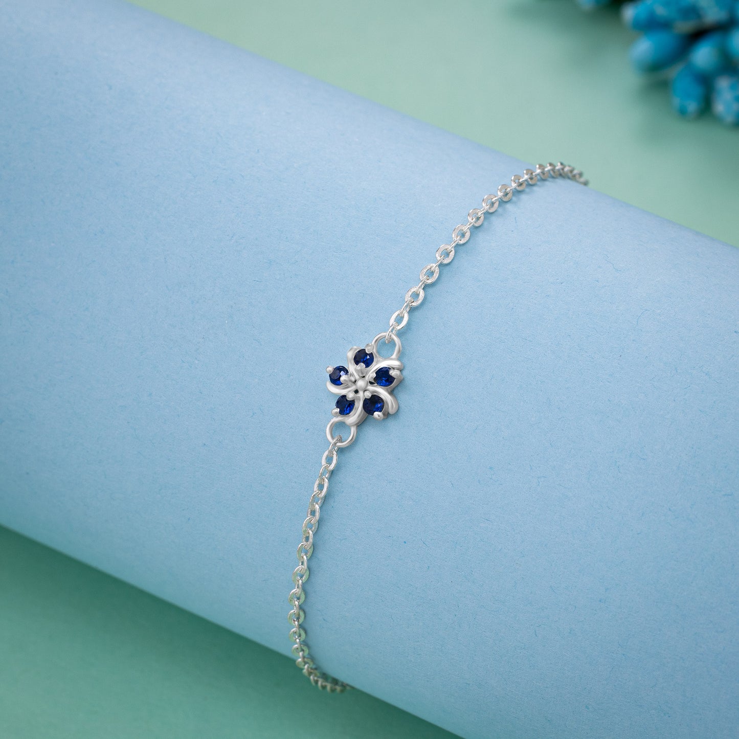 silver bracelet with a blue stone