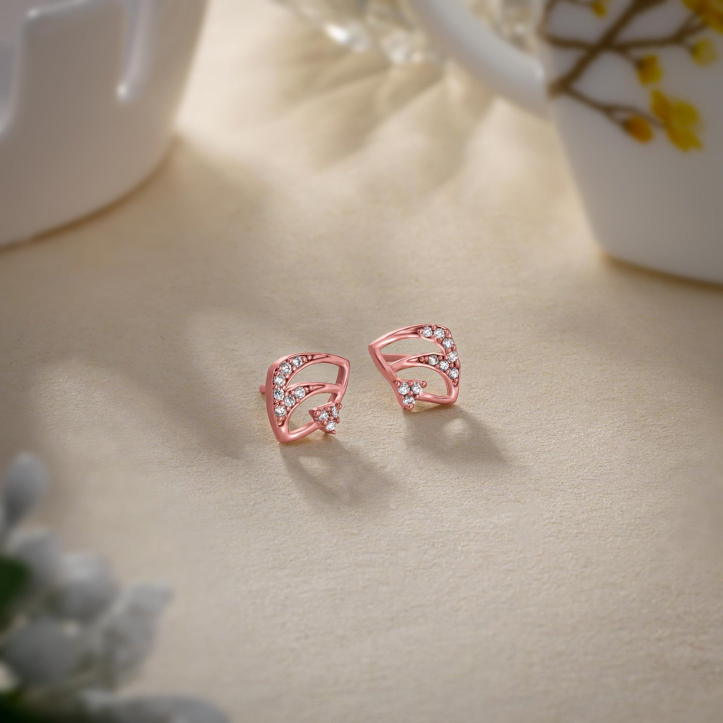 pair of elegant rose gold earrings adorned with sparkling diamonds