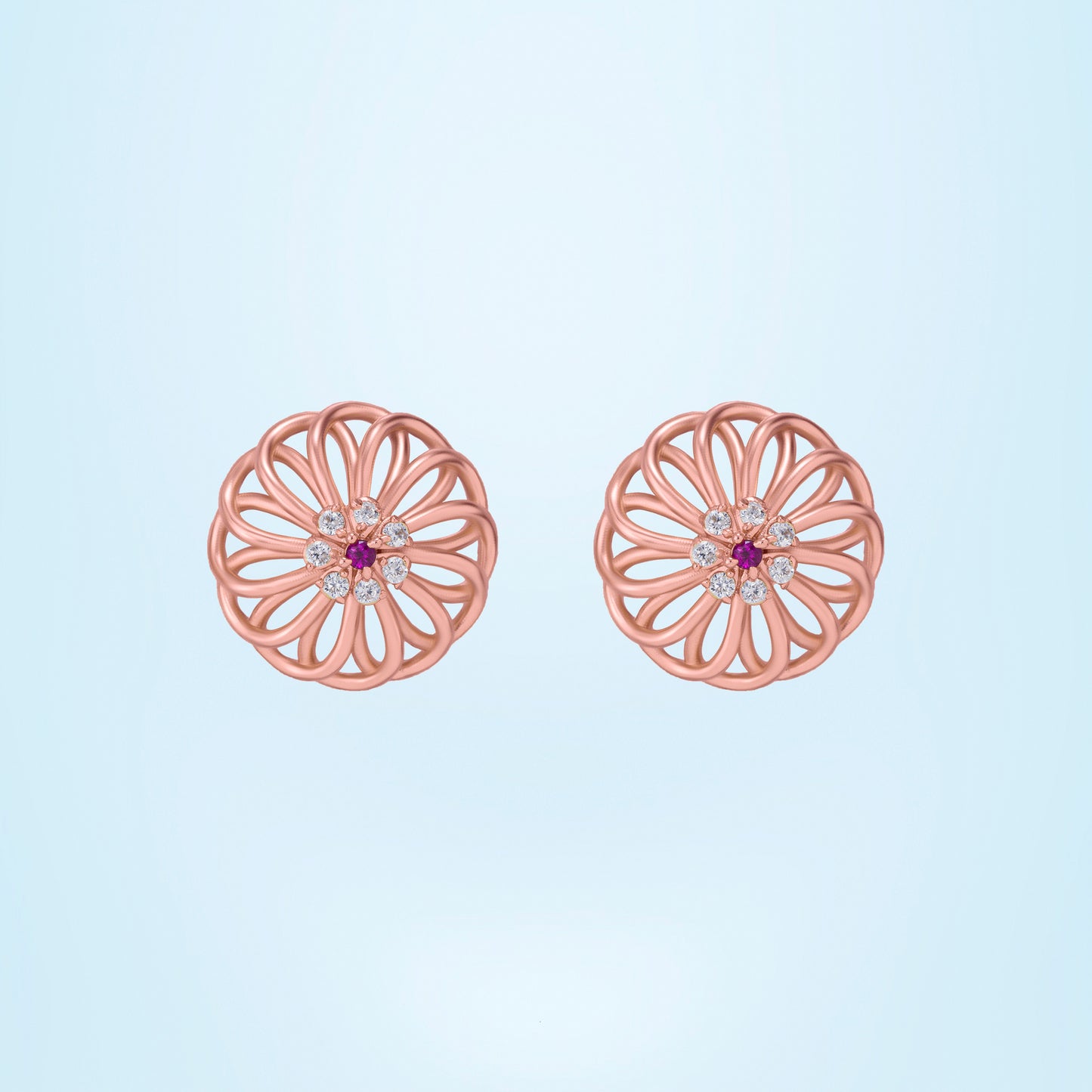 pair of rose gold earrings with diamonds and ruby