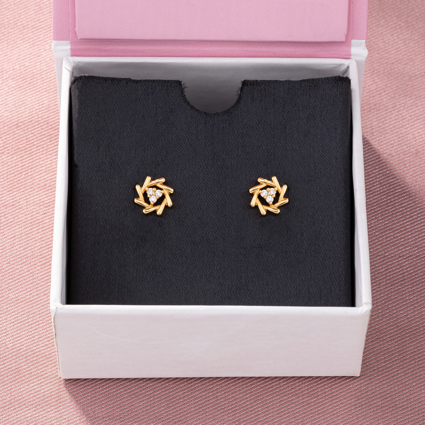 pair of golden earrings with a diamond