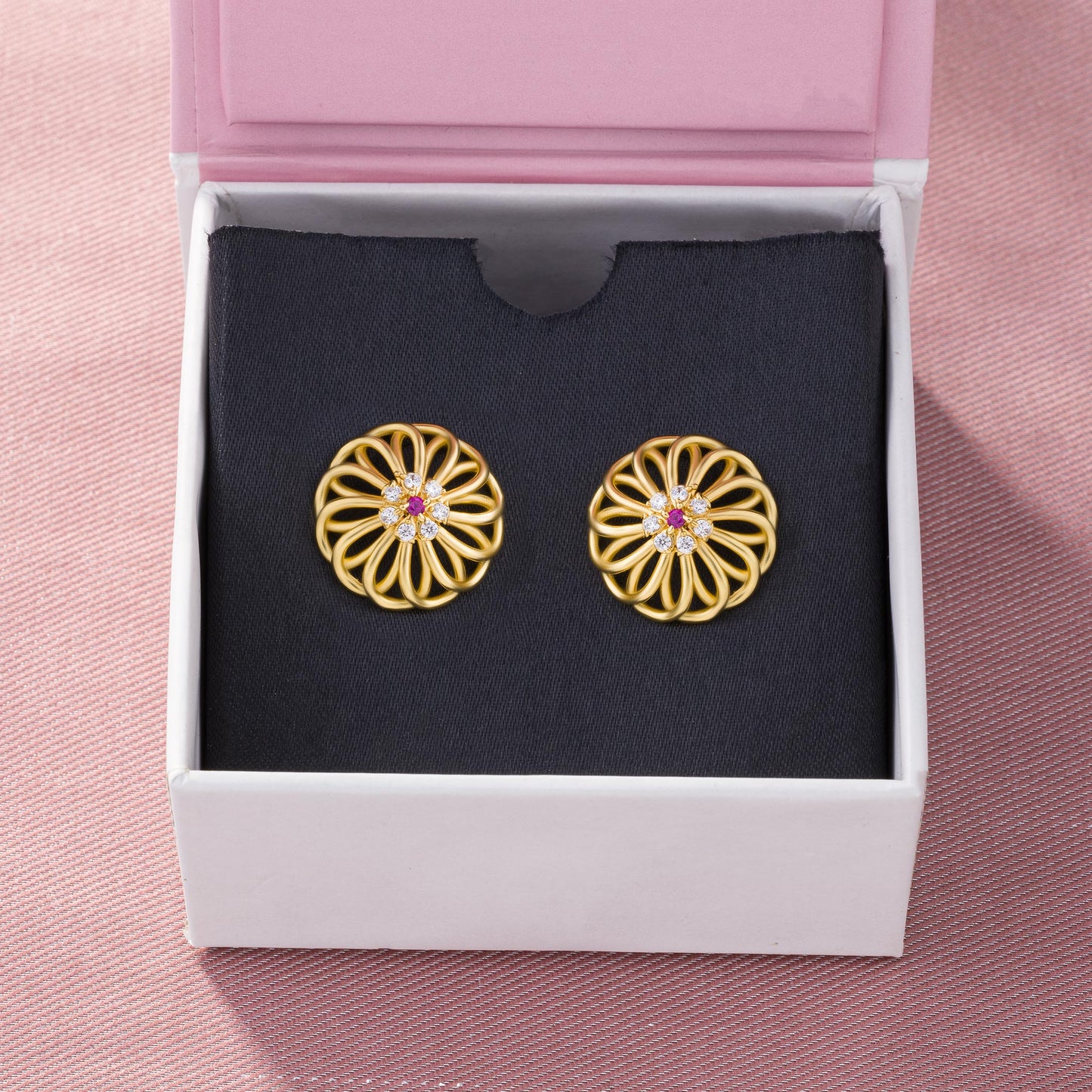 pair of golden earrings with diamonds and ruby