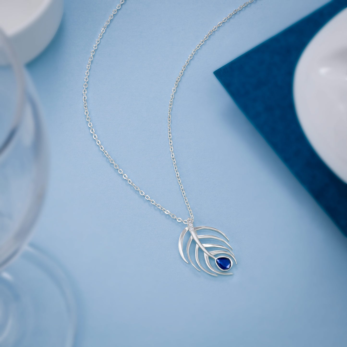 silver necklace with a blue stone