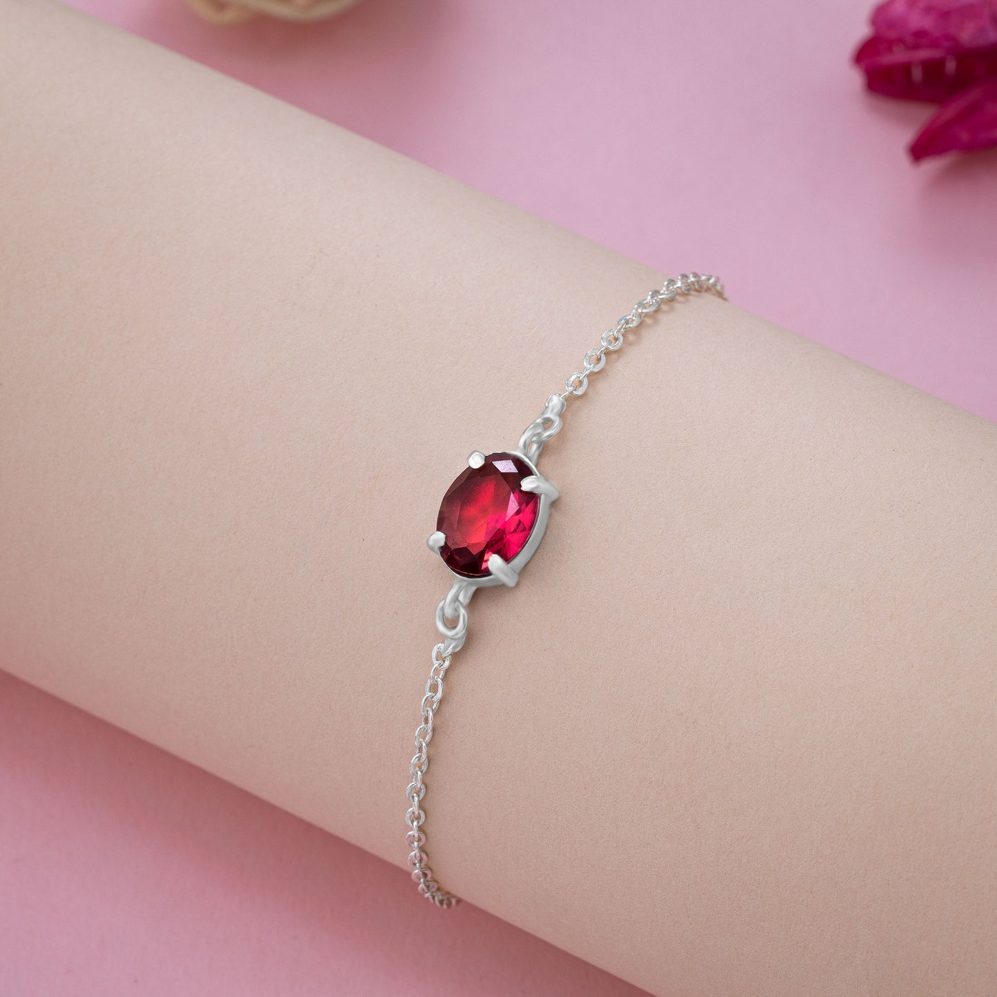 silver bracelet with a red stone