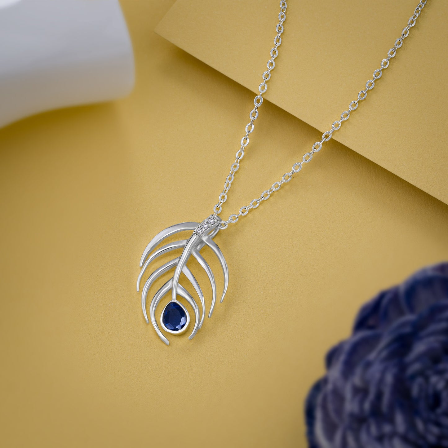 silver necklace with a blue stone