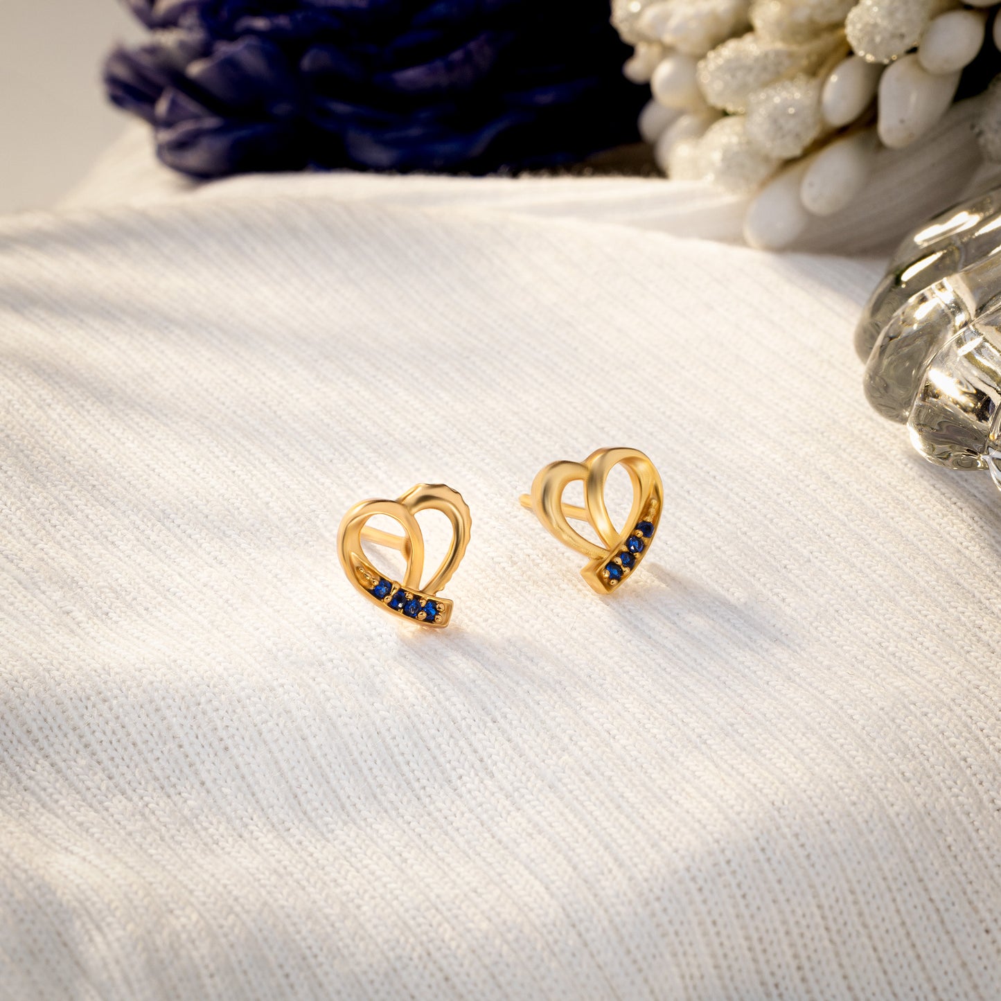 pair of golden earrings with sapphire stones