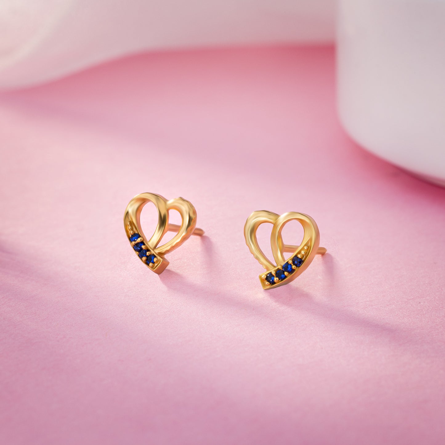 pair of golden earrings with sapphire stones