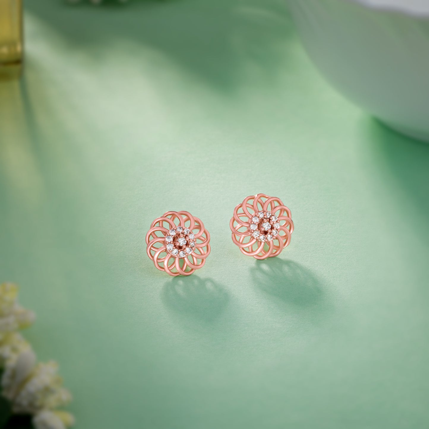 pair of rose gold earrings with diamonds