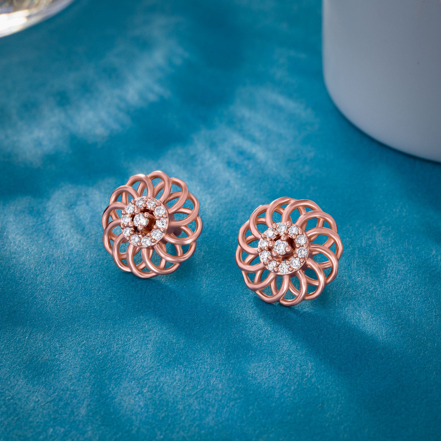 pair of rose gold earrings with diamonds