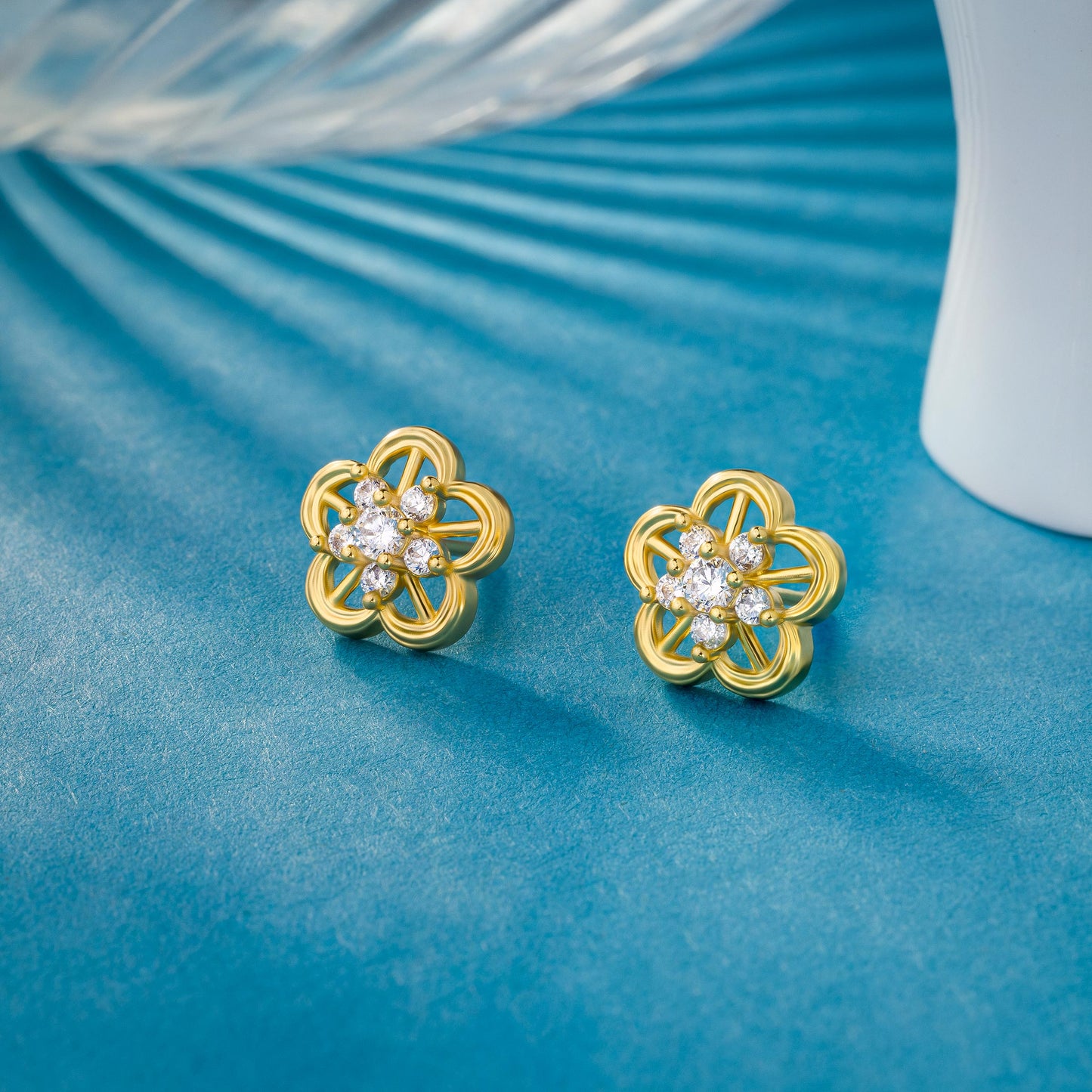 pair of golden earrings with a flower design