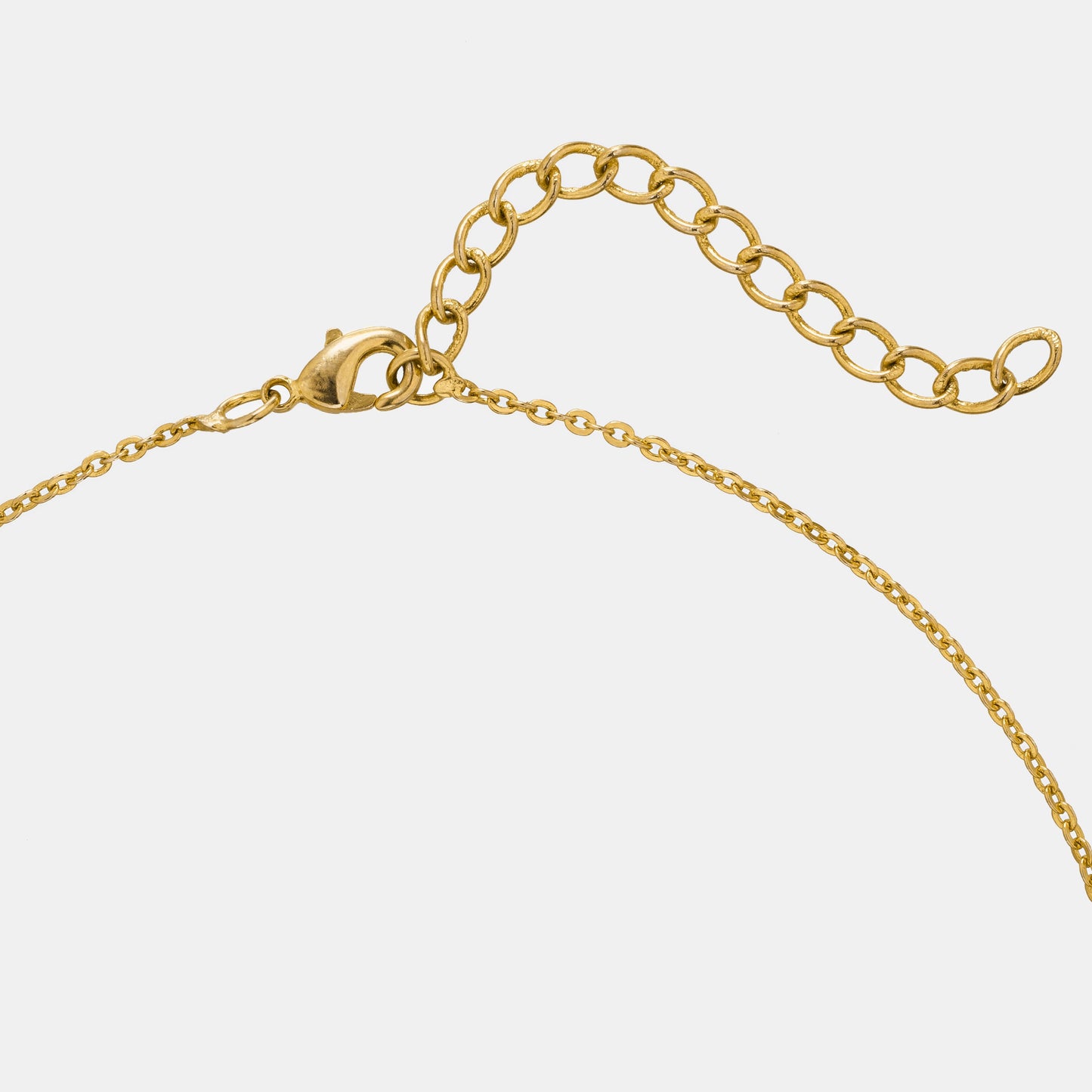 golden necklace with a small diamond on the front