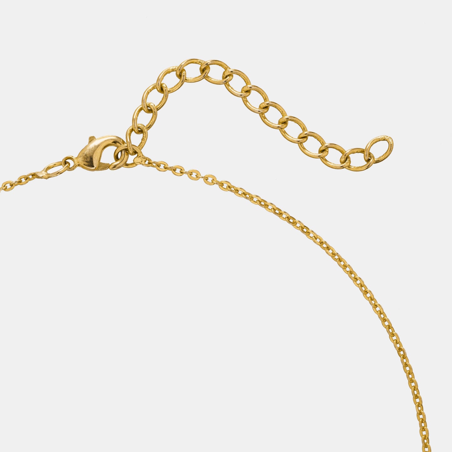 golden necklace with two crossed crosses on it