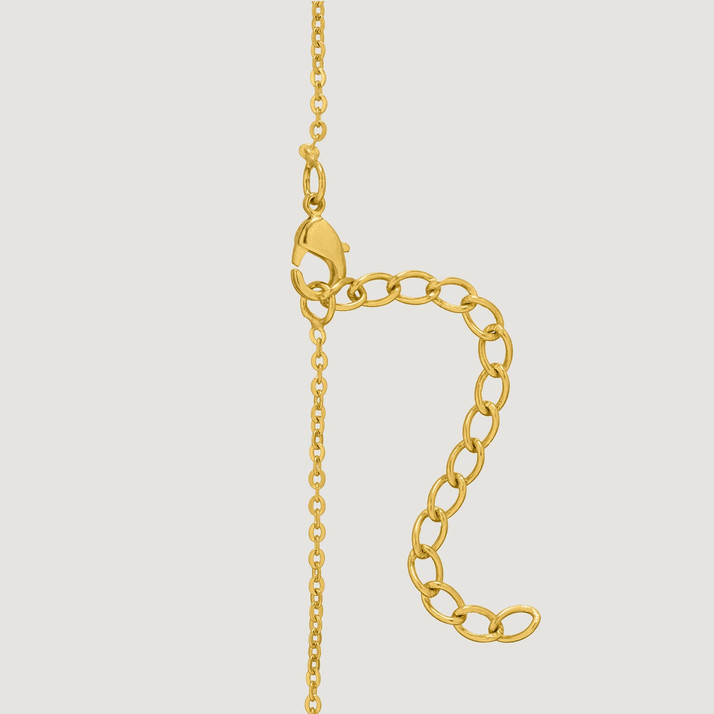 golden necklace with a diamond letter on it