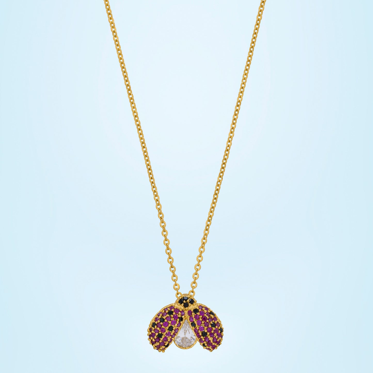 golden necklace with lady bug pendant