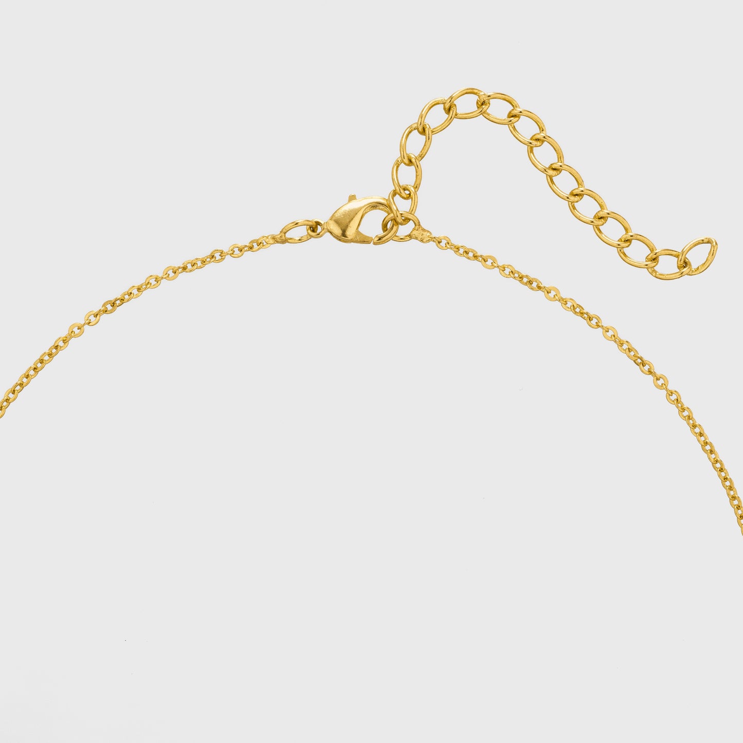 golden necklace with a heart pendant and a small diamond