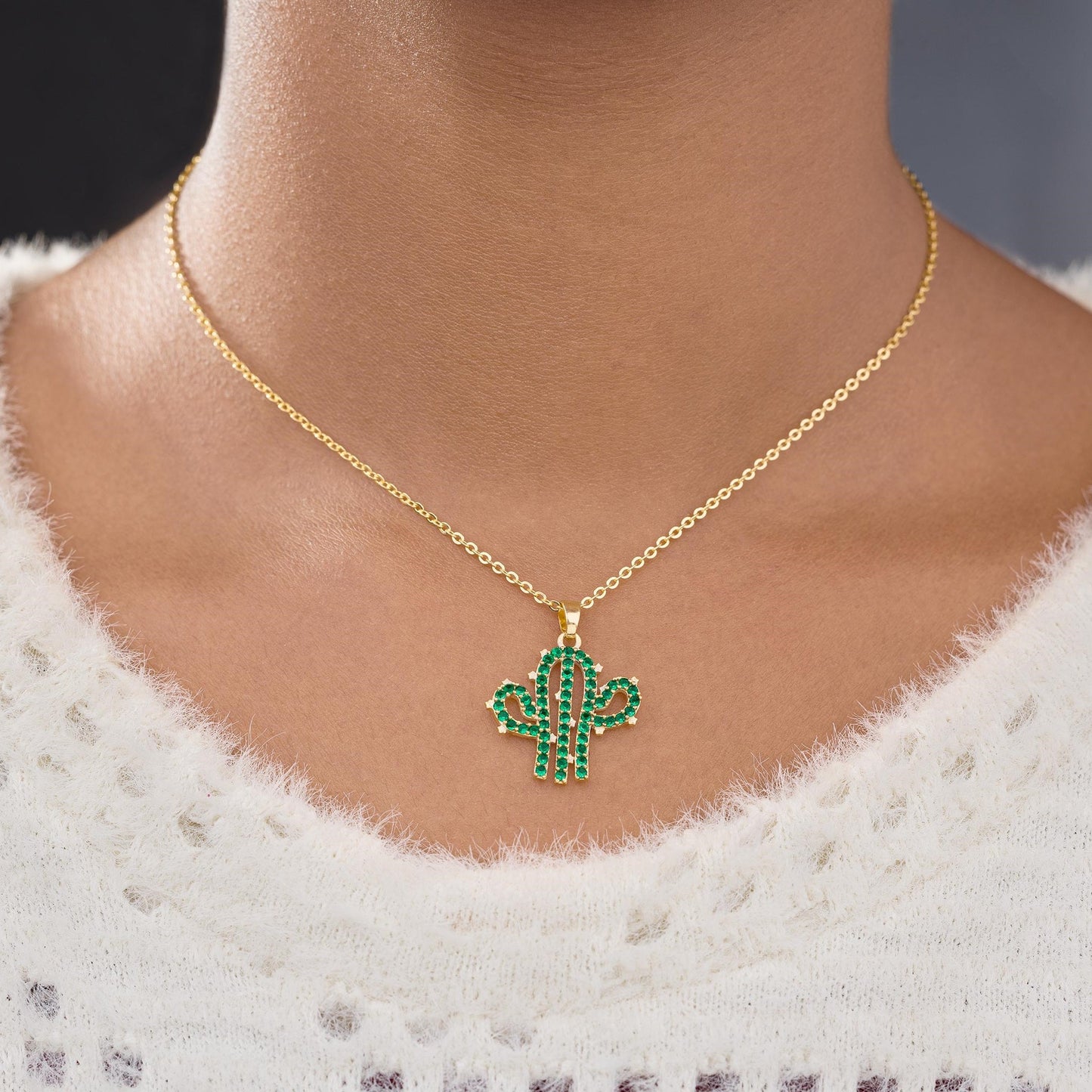 necklace with a cactus charm on it